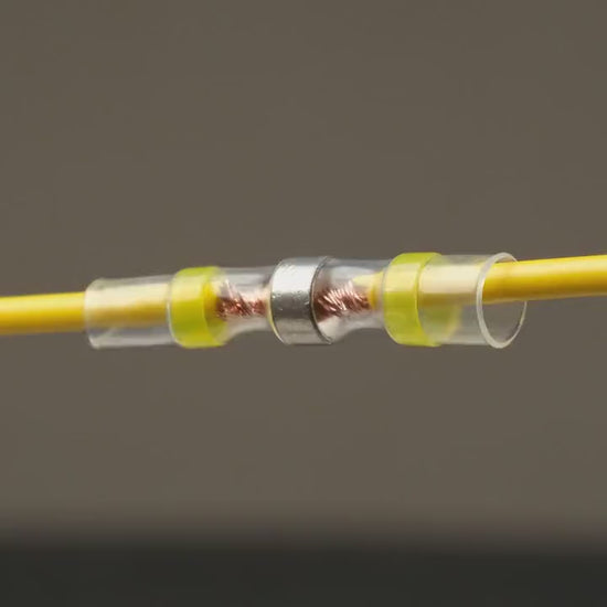Heat shrinks a SolderStick connector: the solder ring melts and seals the joint