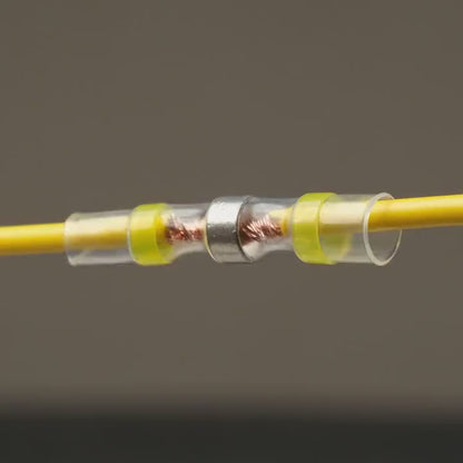 Heat shrinks a SolderStick connector: the solder ring melts and seals the joint