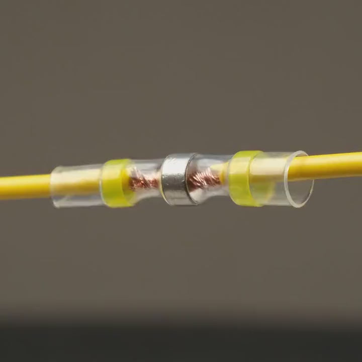 Heat shrinks a SolderStick connector: the solder ring melts and seals the joint